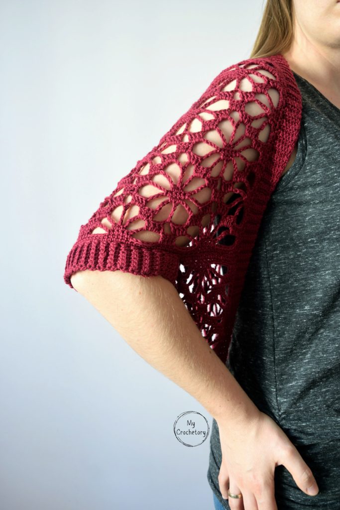 Detailed shot of the ribbed sleeve on a crochet lace shrug pattern.