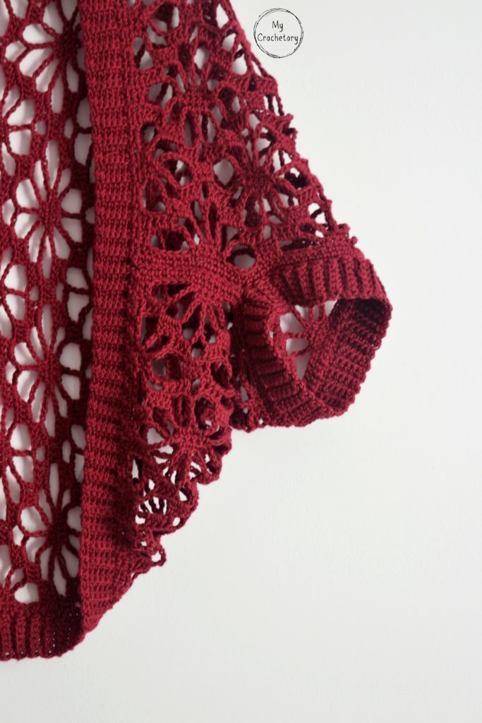 Close-up of sleeve in crochet shrug pattern with ribbed edge.
