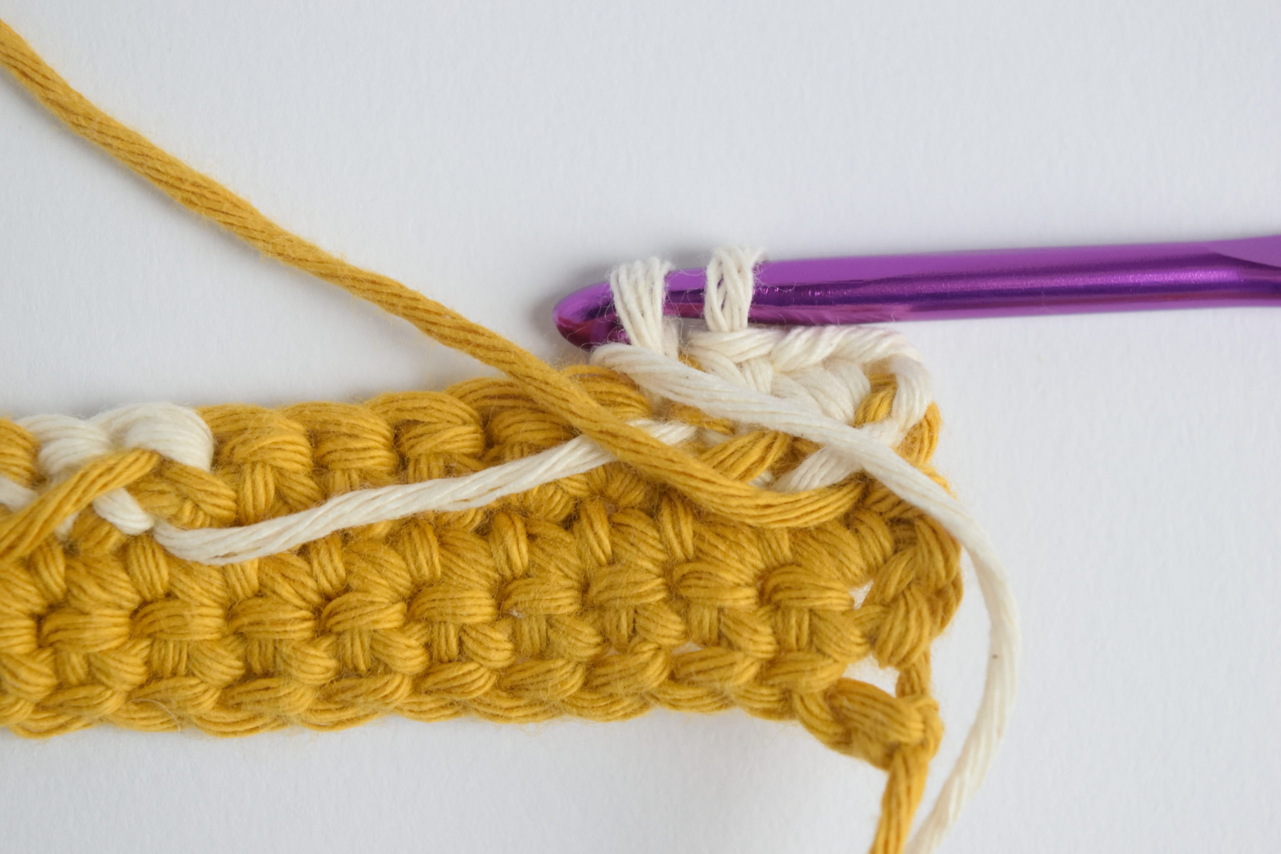 An image showcasing the intarsia crochet technique, featuring multiple colors of yarn worked seamlessly in a crochet project. Explore the beauty and versatility of intarsia crochet with this modern and elegant design.