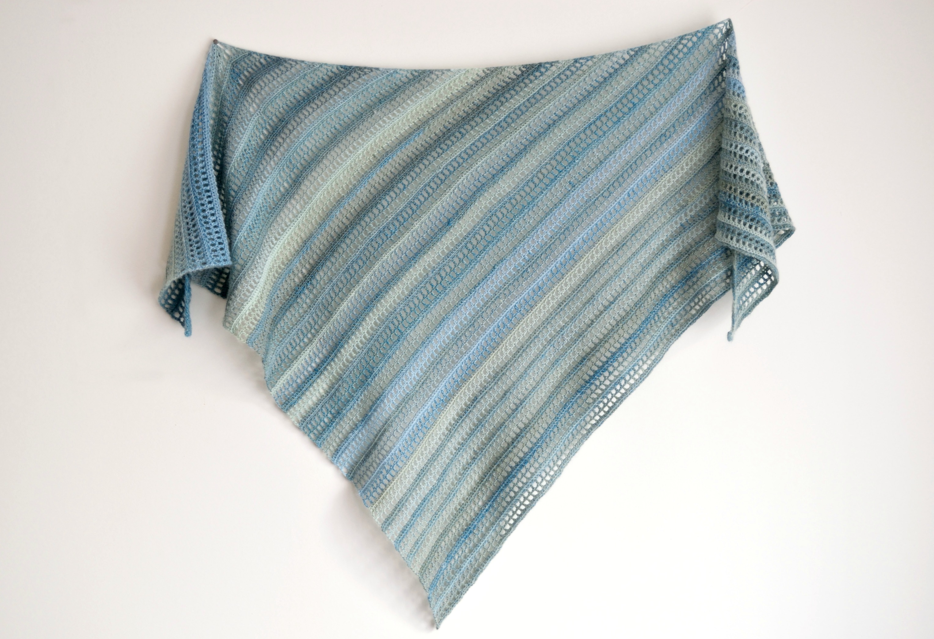 Close-up of the Aprilis crochet shawl in blue gradient yarn