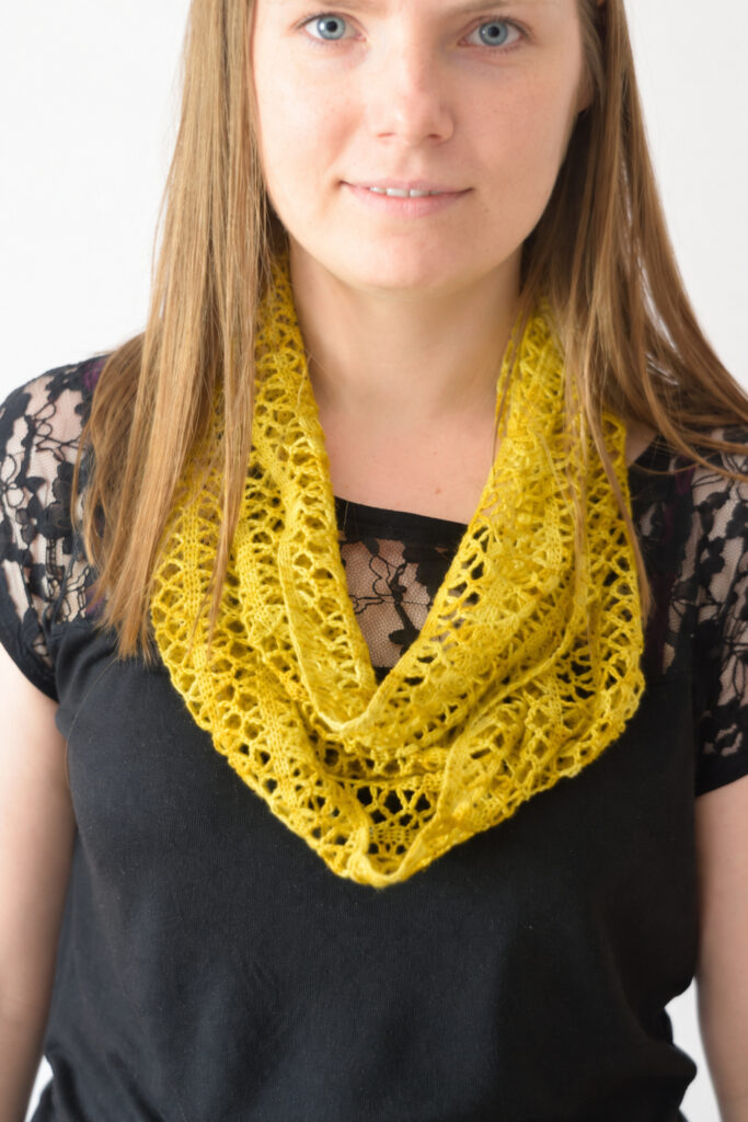 Sunny Lace Cowl wrapped twice around the neck, a light ochre lace infinity scarf