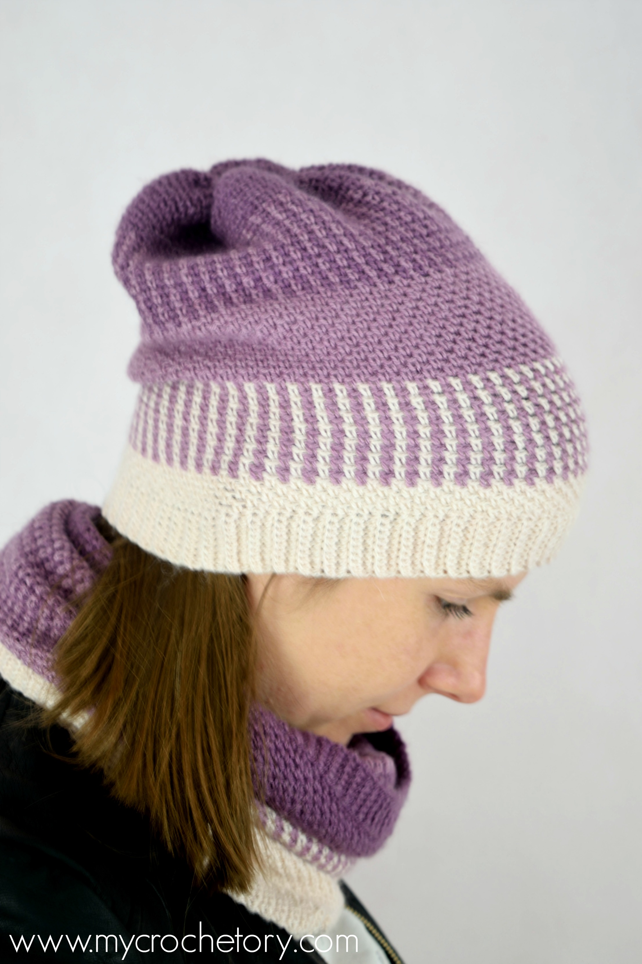 Ombre Moss Stitch Beanie free crochet pattern, a woman wearing a purple ombre moss stitch beanie with a ribbed brim