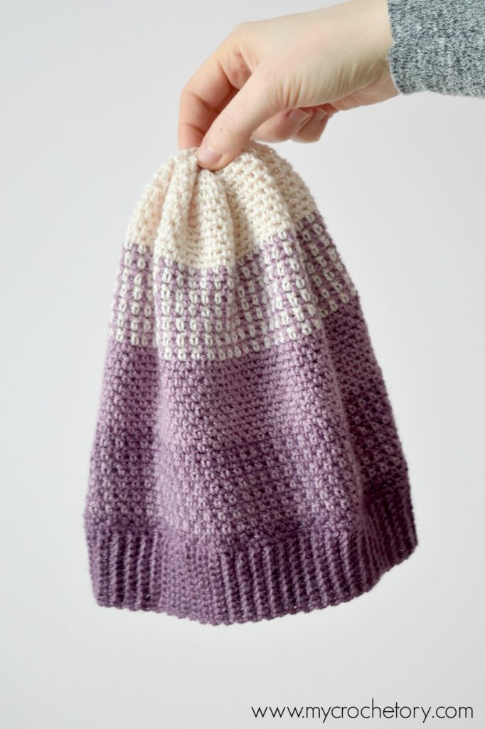 Learn how to crochet a hat. A close-up of the Ombre Moss Stitch Beanie, showcasing its elegant gradient effect and intricate stitch pattern