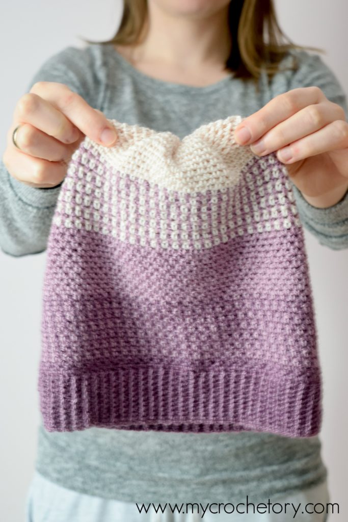 Learn how to crochet a hat. A close-up of the Ombre Moss Stitch Beanie, showcasing its elegant gradient effect and intricate stitch pattern