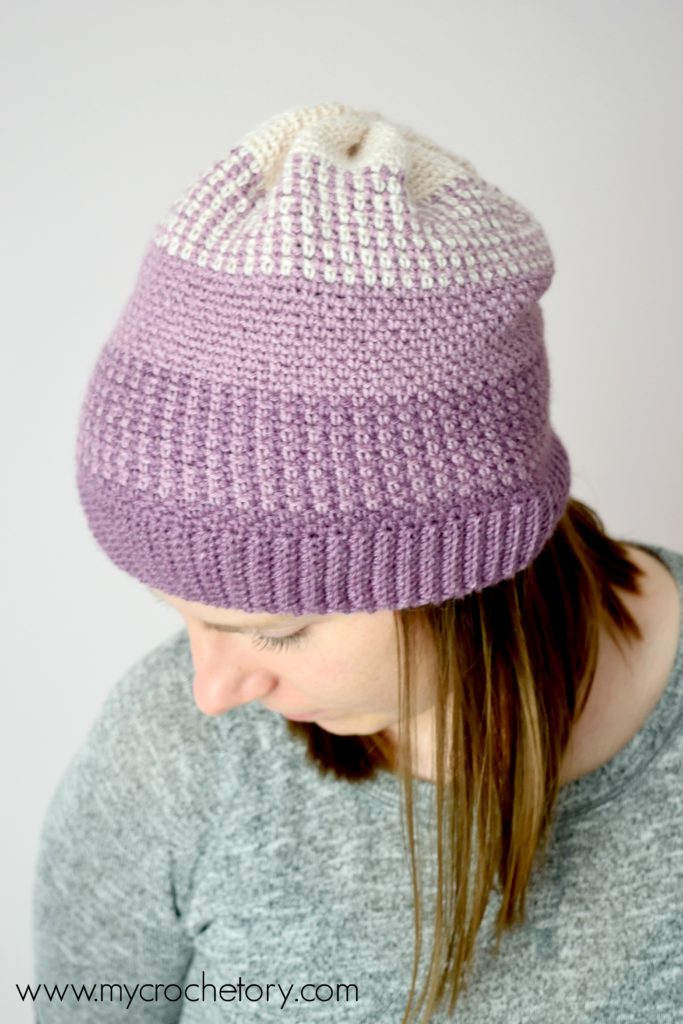 Learn how to crochet a hat. A close-up of the Ombre Moss Stitch Beanie, showcasing its elegant gradient effect and intricate stitch pattern