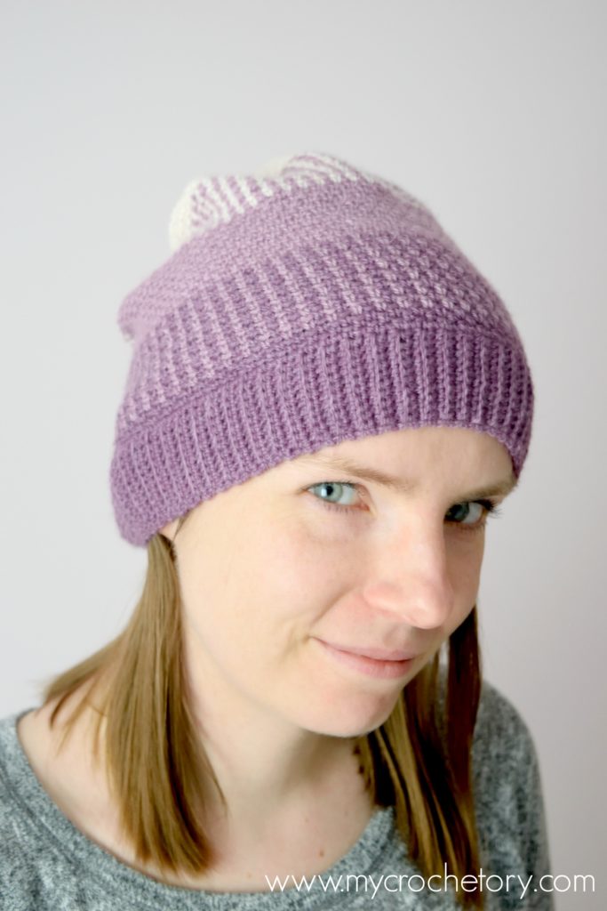 Learn how to crochet a hat. A close-up of the Ombre Moss Stitch Beanie, showcasing its elegant gradient effect and intricate stitch pattern