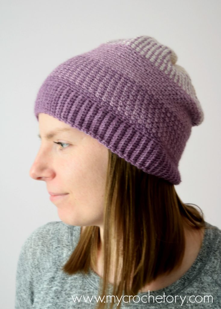 Learn how to crochet a hat. A close-up of the Ombre Moss Stitch Beanie, showcasing its elegant gradient effect and intricate stitch pattern