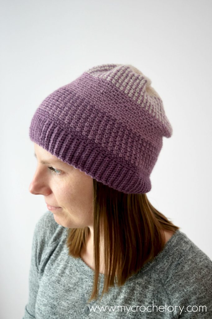 Learn how to crochet a hat. A close-up of the Ombre Moss Stitch Beanie, showcasing its elegant gradient effect and intricate stitch pattern