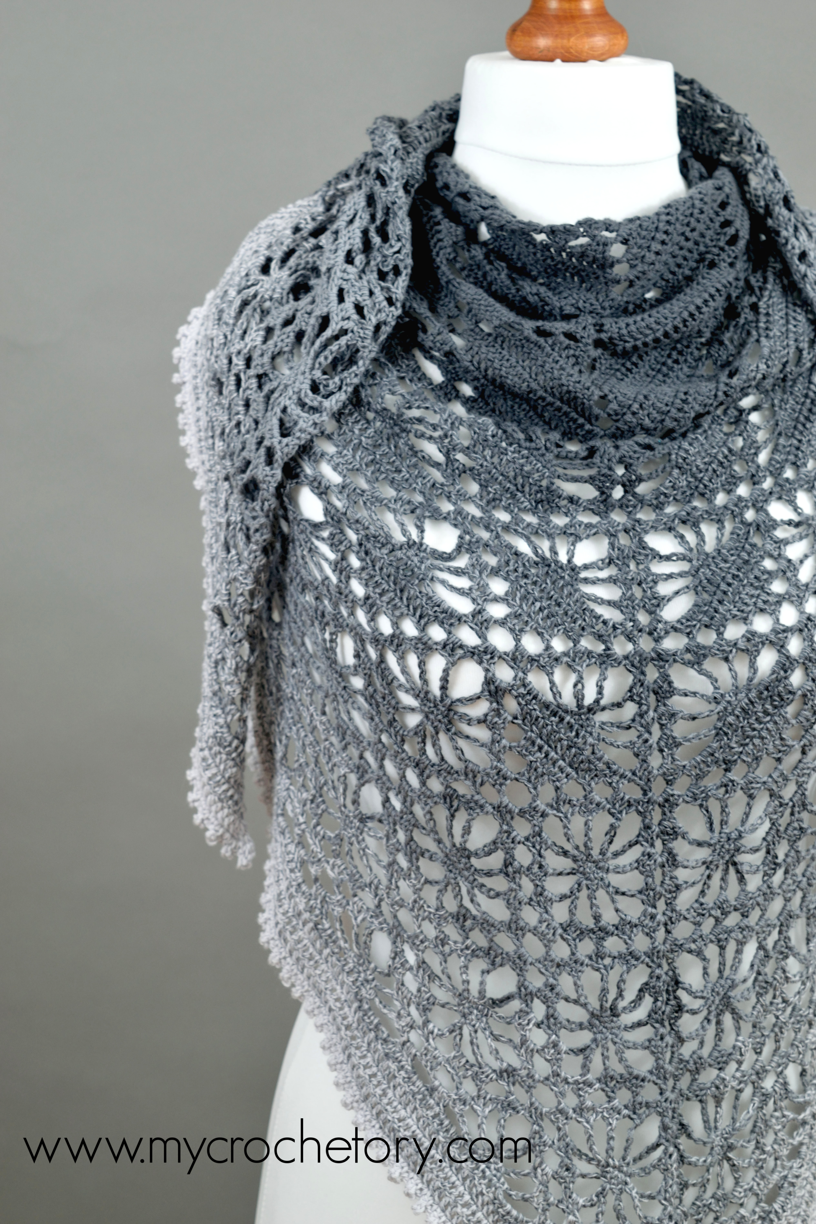 Leto crochet shawl on a mannequin, dark gray at the neck and light gray at the picot edge