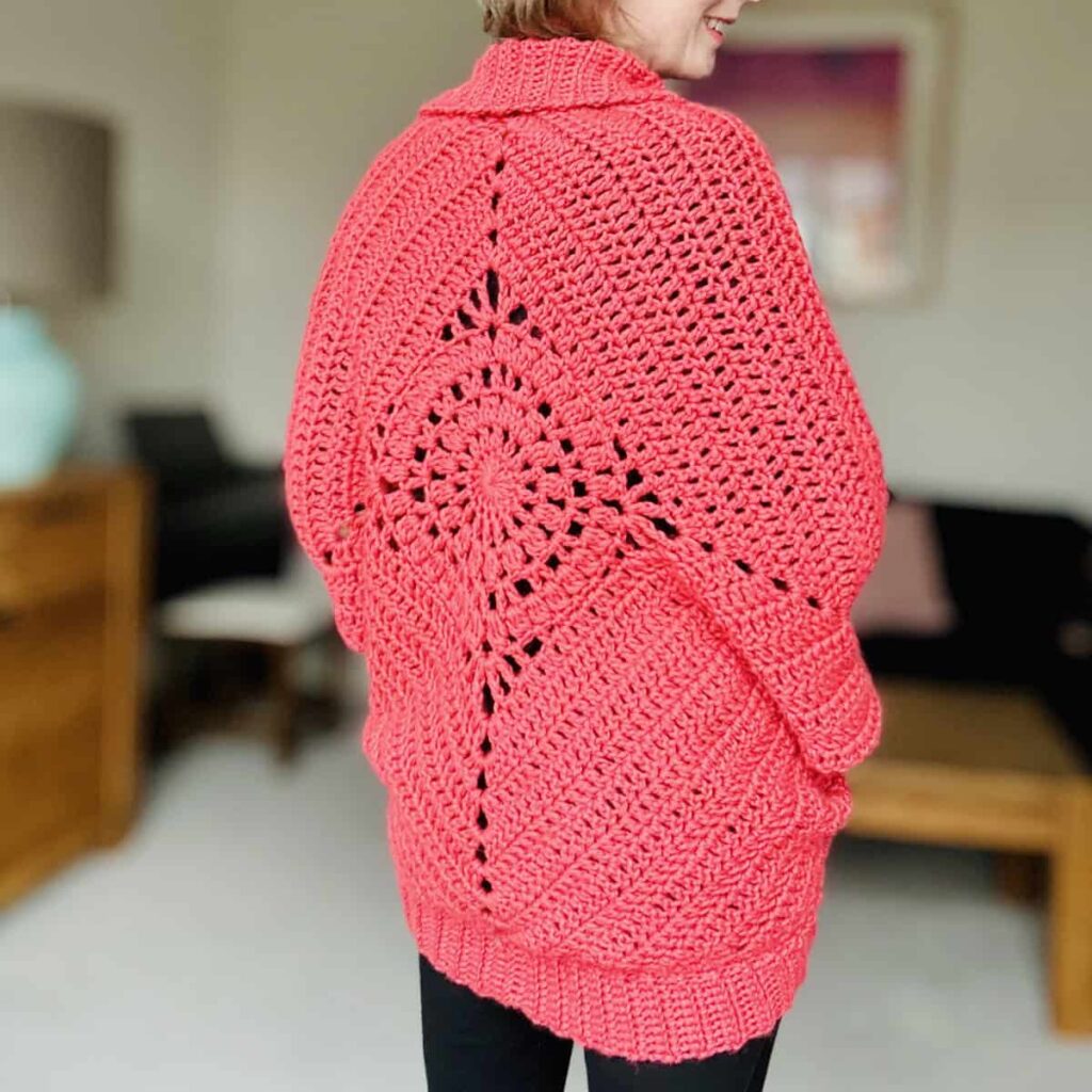 Dream Catcher Cardi in coral, back view showing the lace diamond motif in the middle of the cocoon cardigan