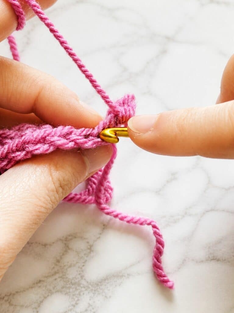Inserting crochet hook into the back loop only for back loop single crochet ribbing technique