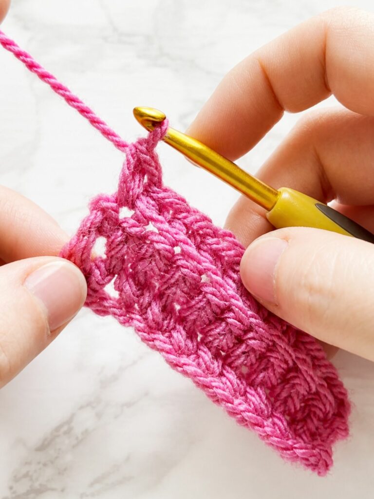 Close up of the last single crochet stitch worked under both loops in back loop single crochet ribbing