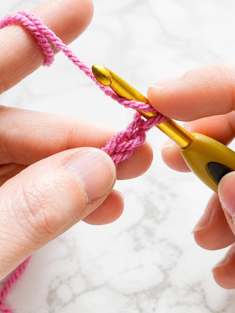 Yarn over and insert the crochet hook into the second chain from the hook while starting yarn over slip stitch crochet ribbing
