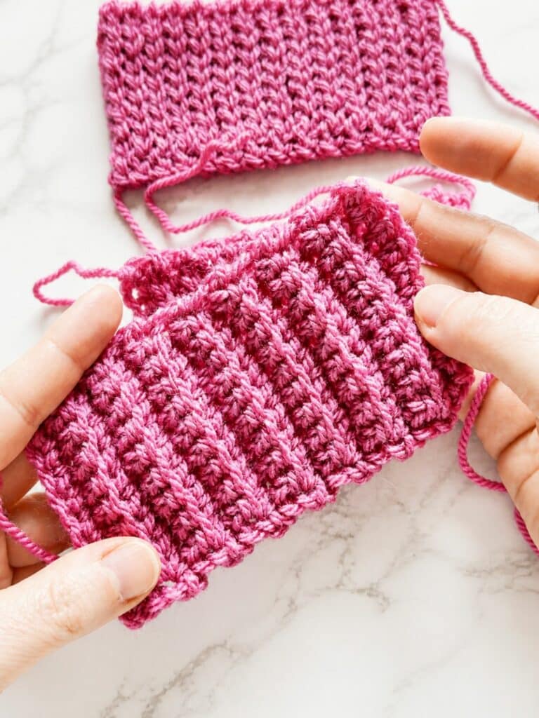 Hands holding a back loop single crochet ribbing swatch with stretchy vertical crochet ridges for cuffs, hats, and sweater hems