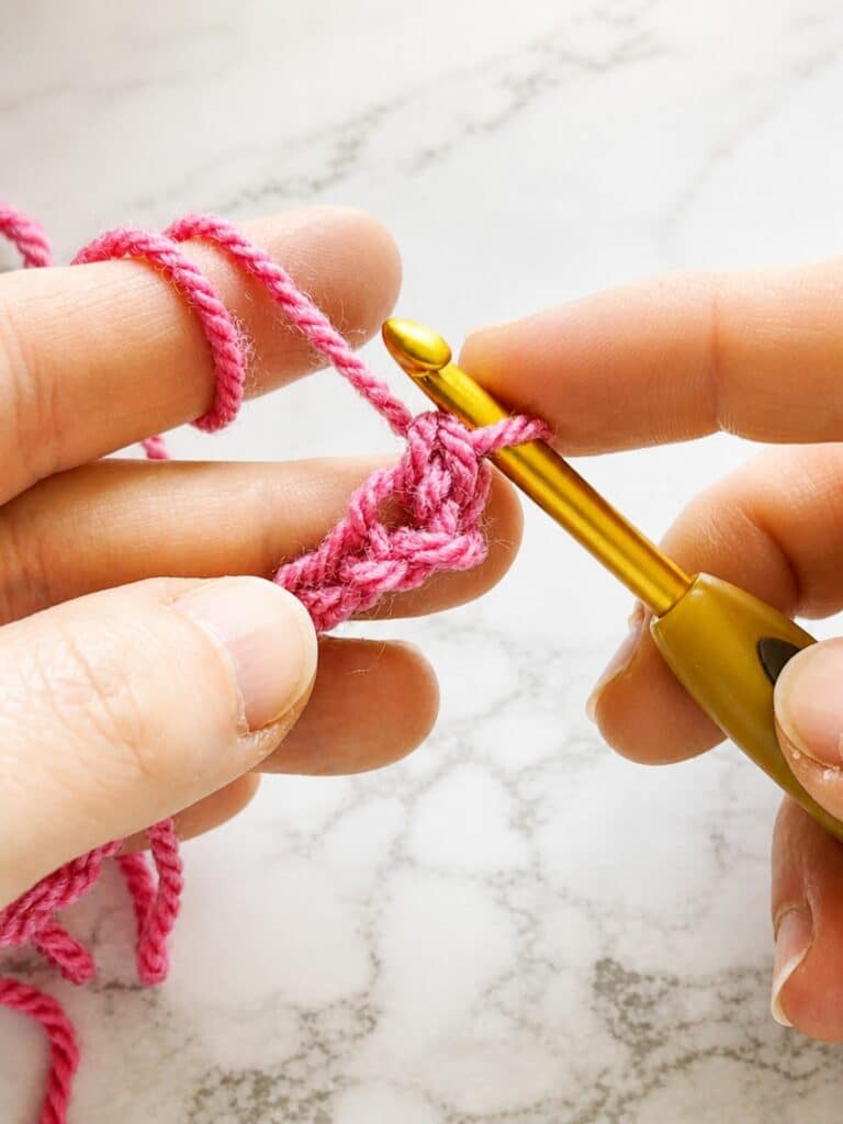 Working the first back loop single crochet stitch into the chain for crochet ribbing