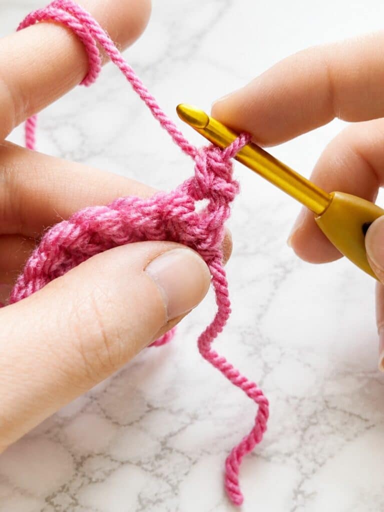 Working the first single crochet of the second row in back loop single crochet ribbing