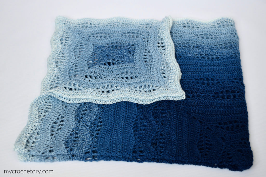 How to crochet a blanket: a beautiful Kalinda Blanket showcasing vibrant waves of color.