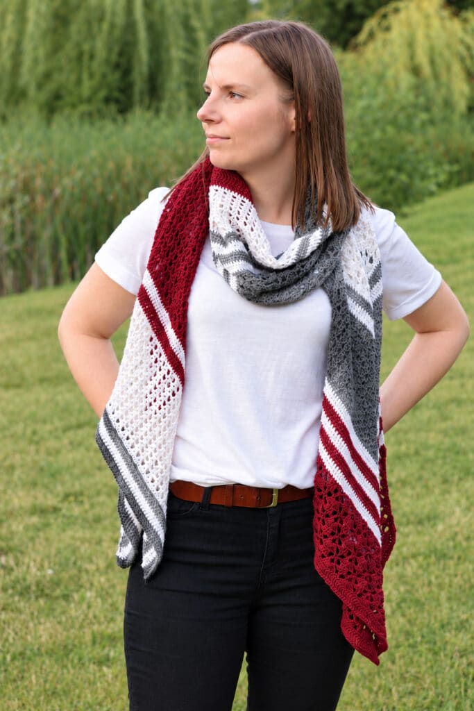 Long crochet wrap with red, white and gray chevron stripes wrapped once around the neck