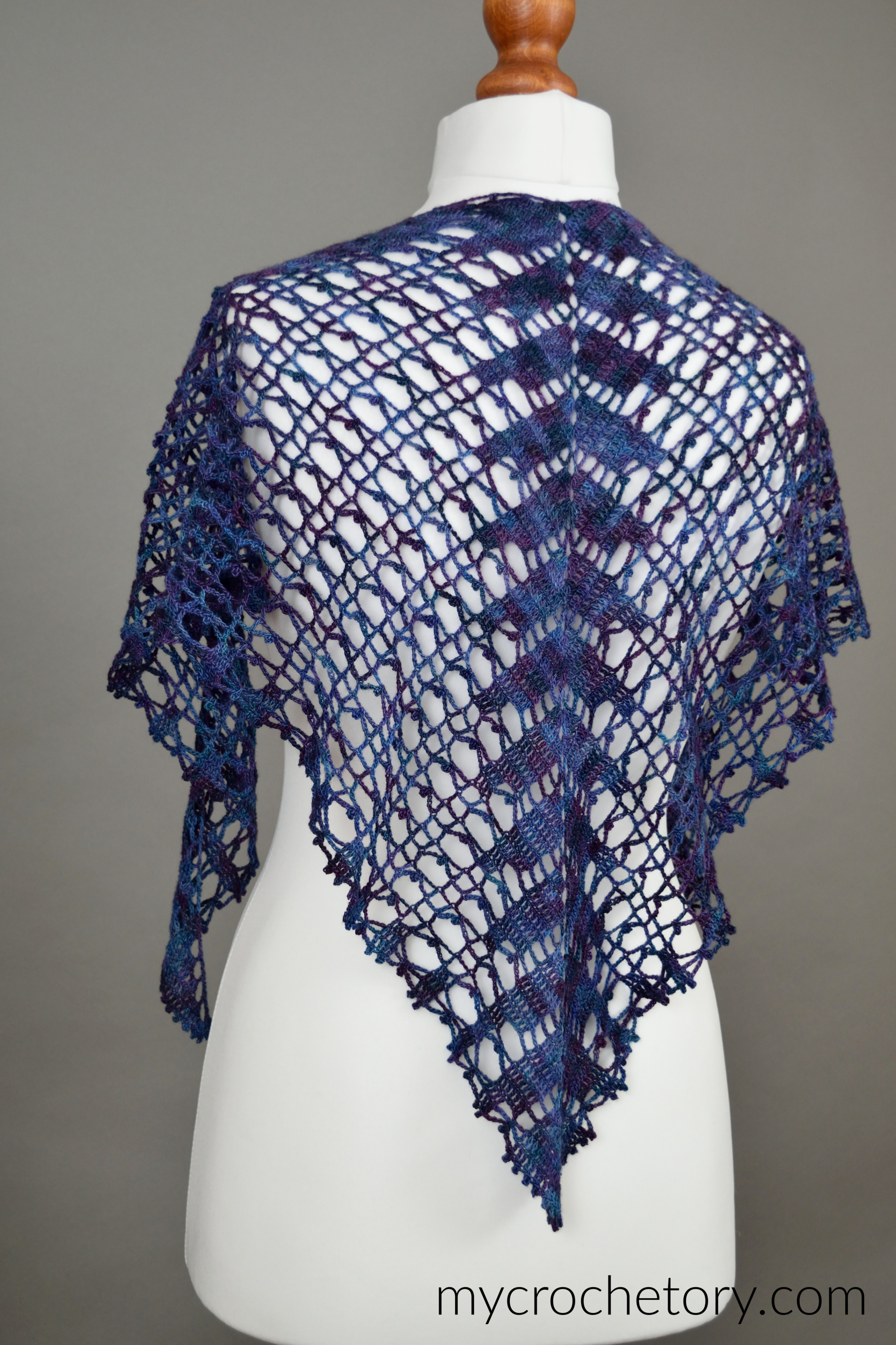 Back of the Lace Shawlette on a mannequin, showing the center spine of the triangle