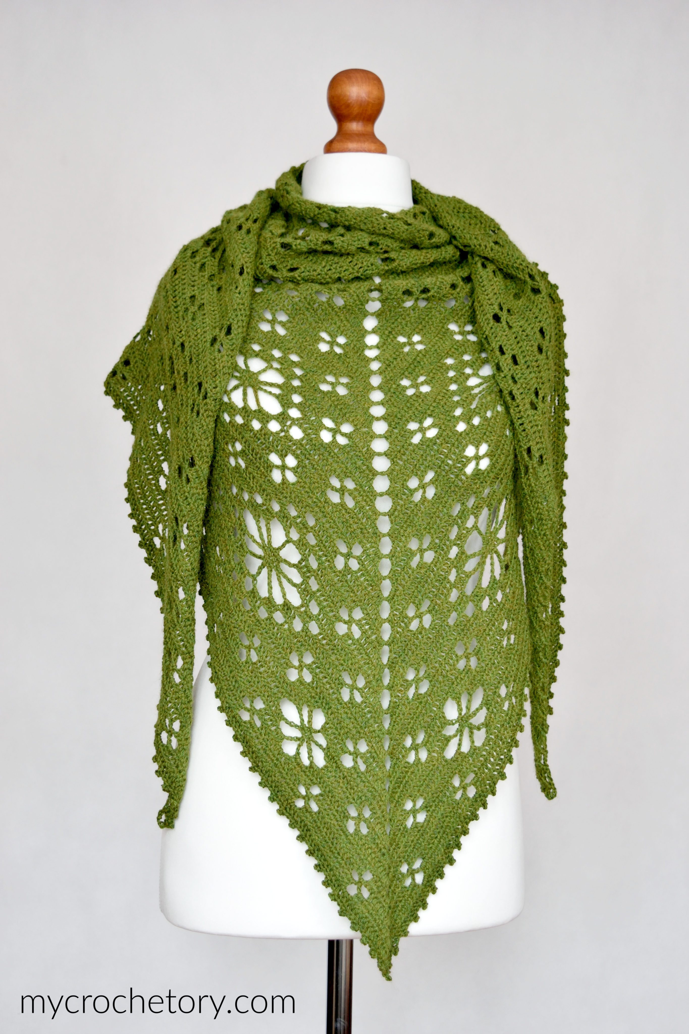 Green flower shawl crochet pattern, the Field of Flowers Shawl wrapped around a mannequin