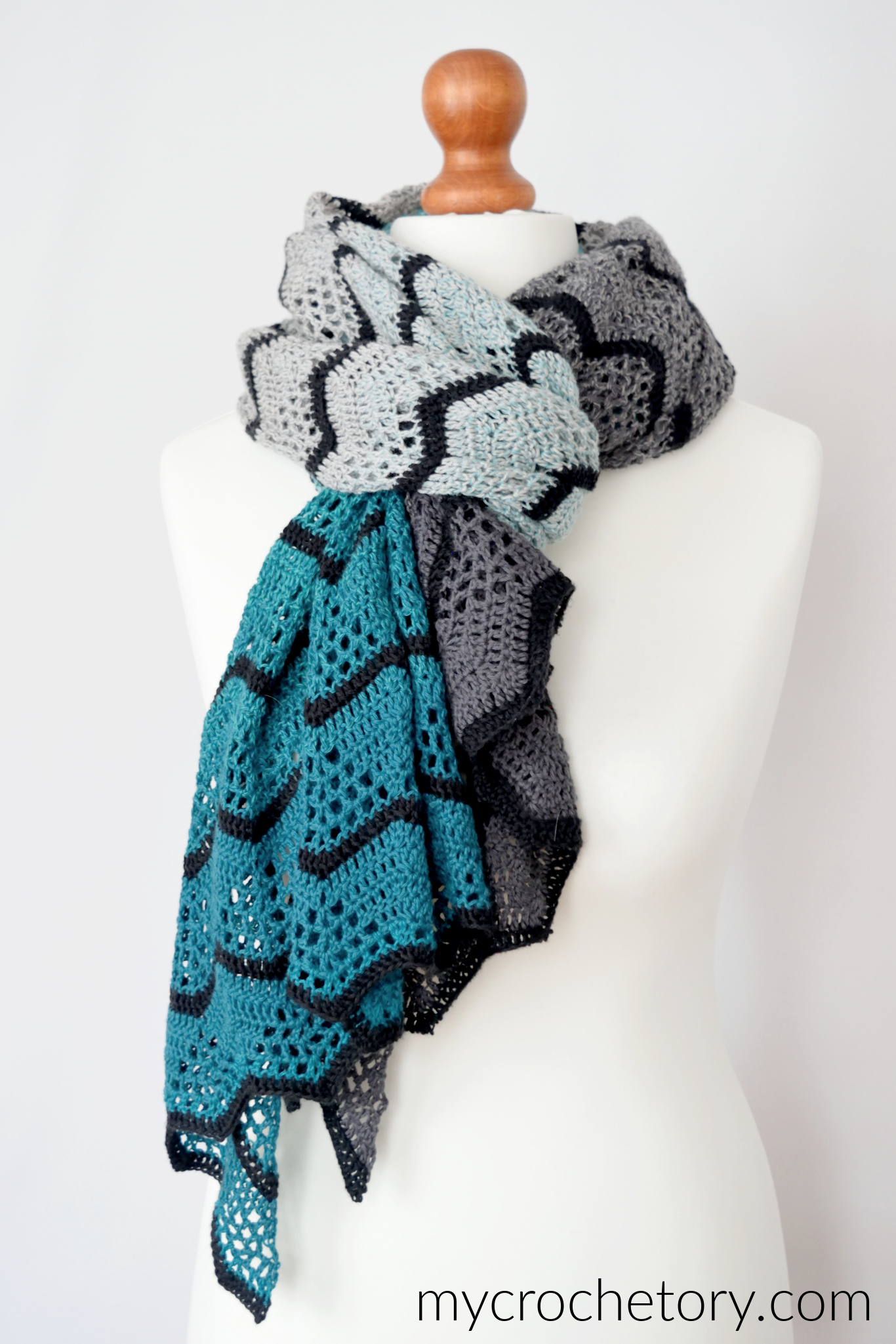 Havra Wrap wrapped around the neck of a mannequin with gray and turquoise chevrons