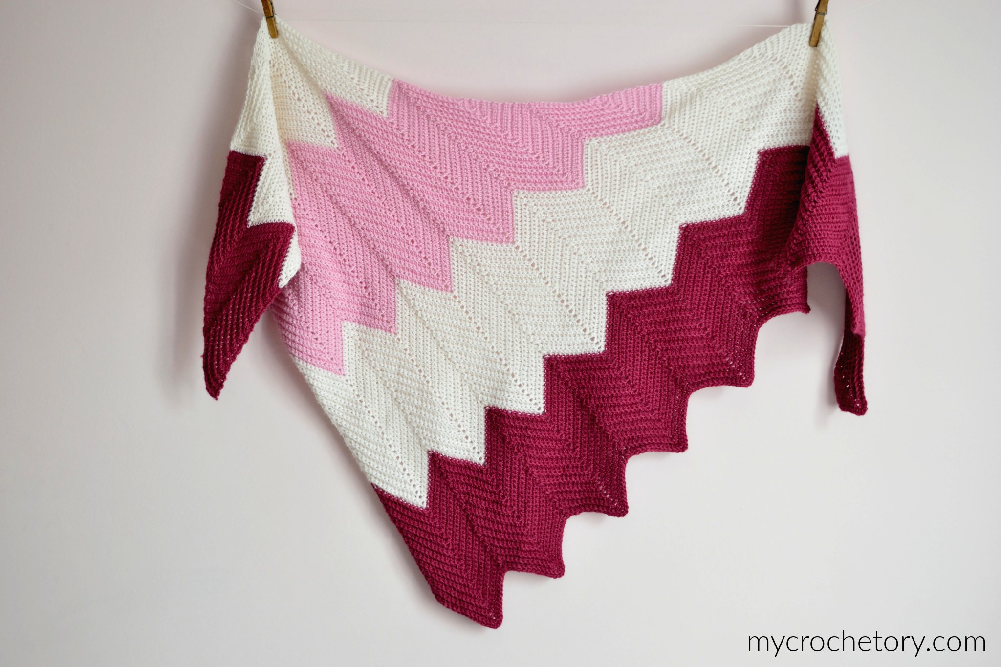 The whole chevron shawl laid out, showing the zigzag sections in three colors