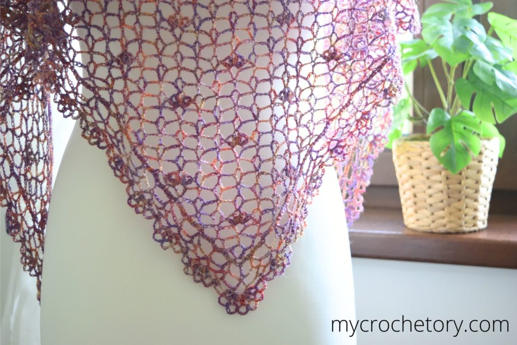 Woman wearing the mustard Greta lace shawl outdoors