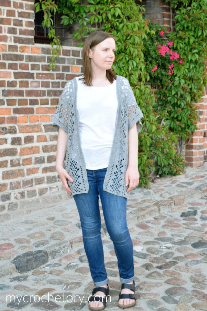 The Nusa Lightweight Crochet Cardigan pattern FREE styled with a white t-shirt and jeans, showcasing its versatility and casual charm.