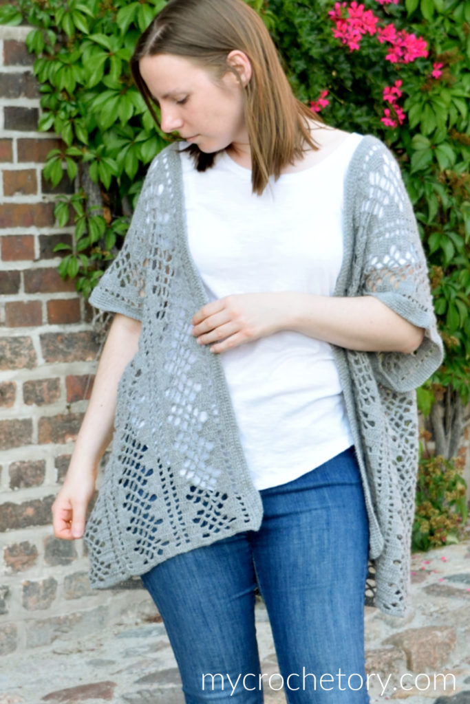 The Nusa Lightweight Crochet Cardigan pattern FREE styled with a white t-shirt and jeans, showcasing its versatility and casual charm.