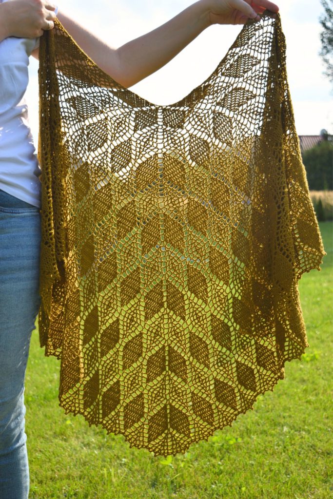 Eira crescent crochet shawl with leaf lace in mustard yellow