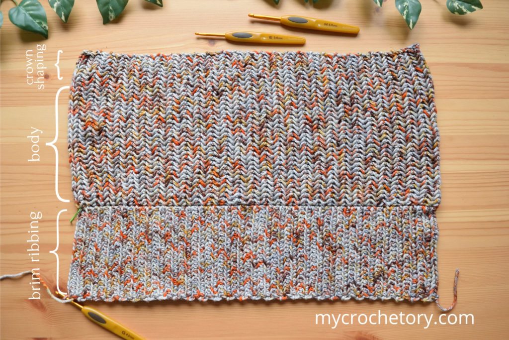 Flat layout of crochet winter hat pattern before assembly