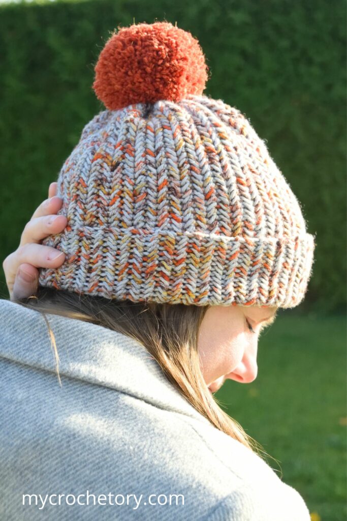 Back view of crochet winter hat pattern with pom pom