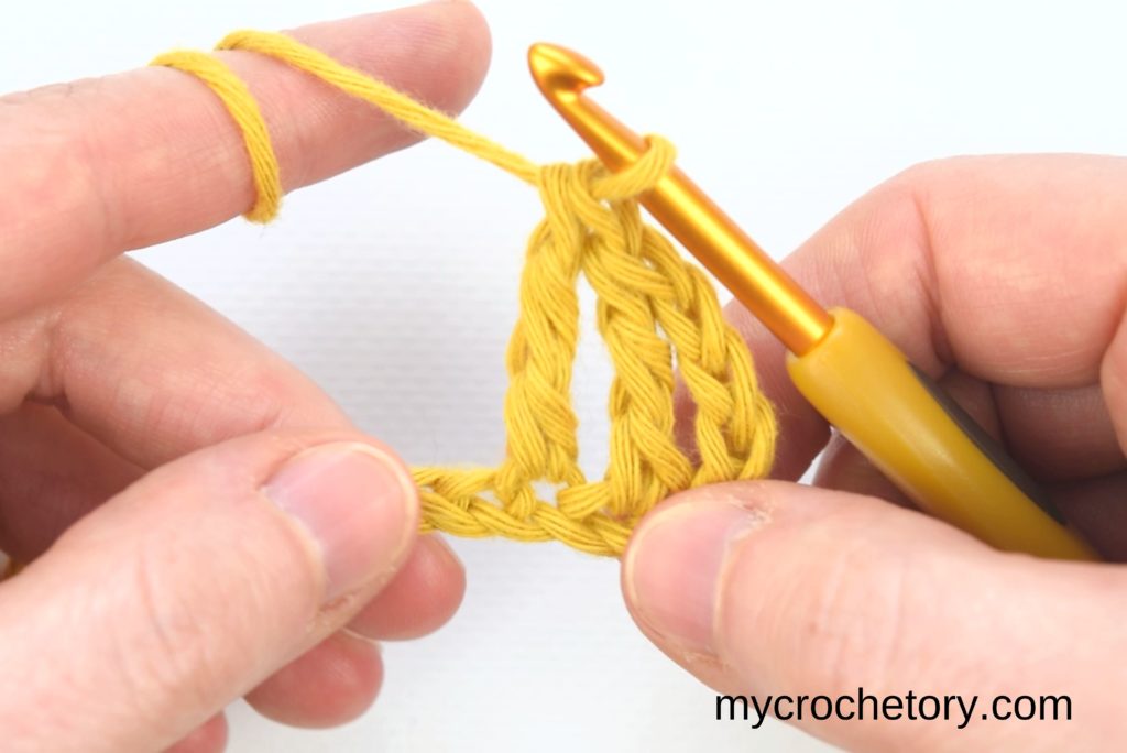 How to treble crochet: first treble crochet stitch completed.
