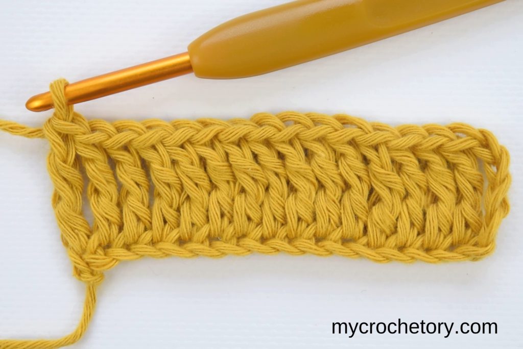 How to treble crochet: first row of treble crochet stitches completed.