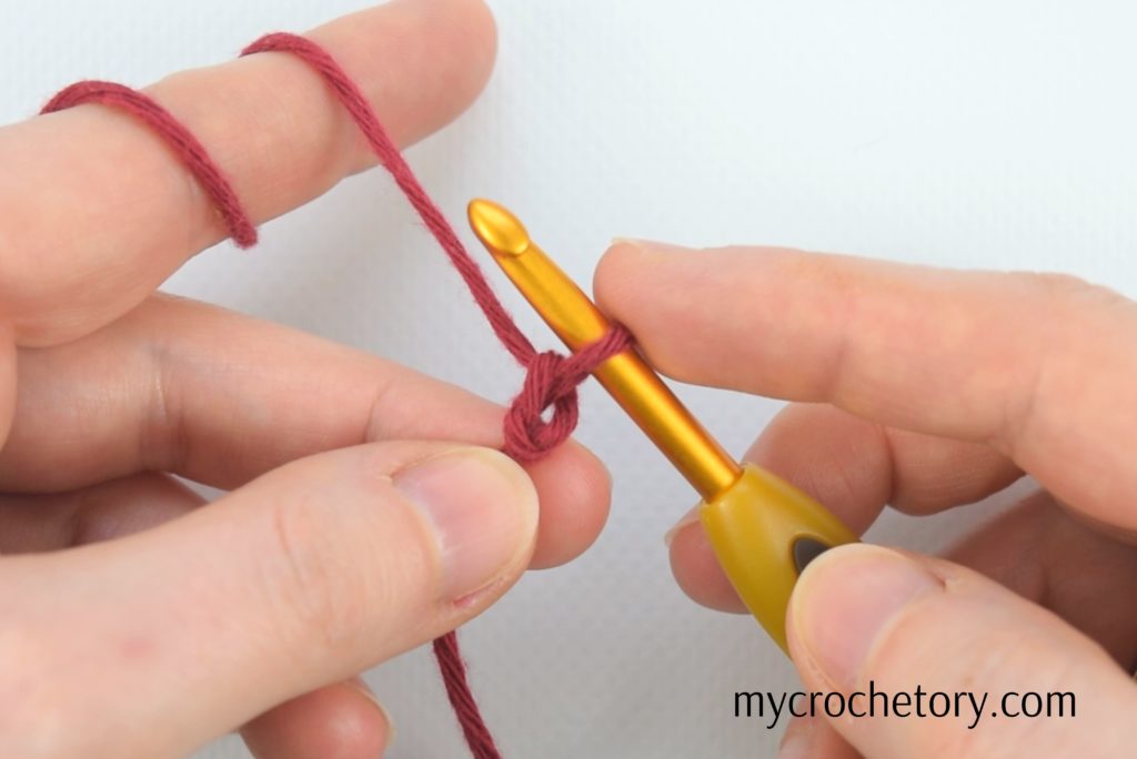 Hands showcasing the first crocheted chain - Learn how to crochet a chain effortlessly with our step-by-step guide!