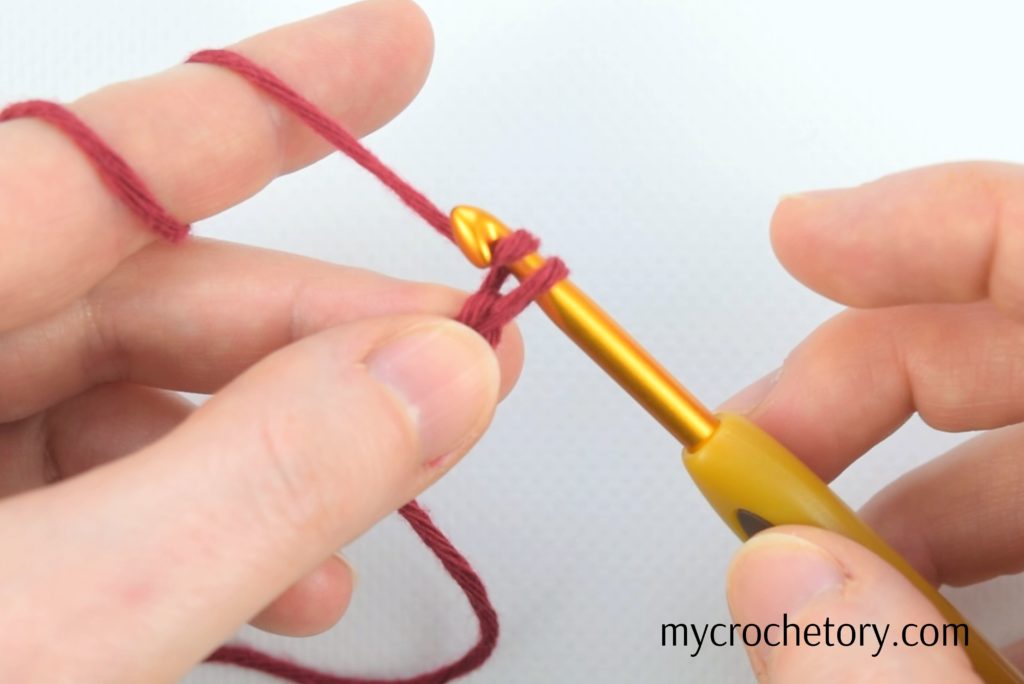 Hands crafting second chain - Learn how to crochet a chain with our simple guide