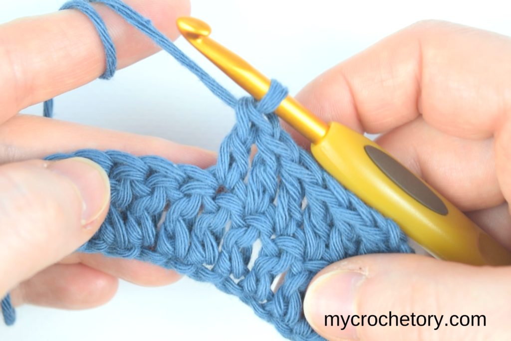 How to double crochet for beginners: working double crochet stitches across the row.