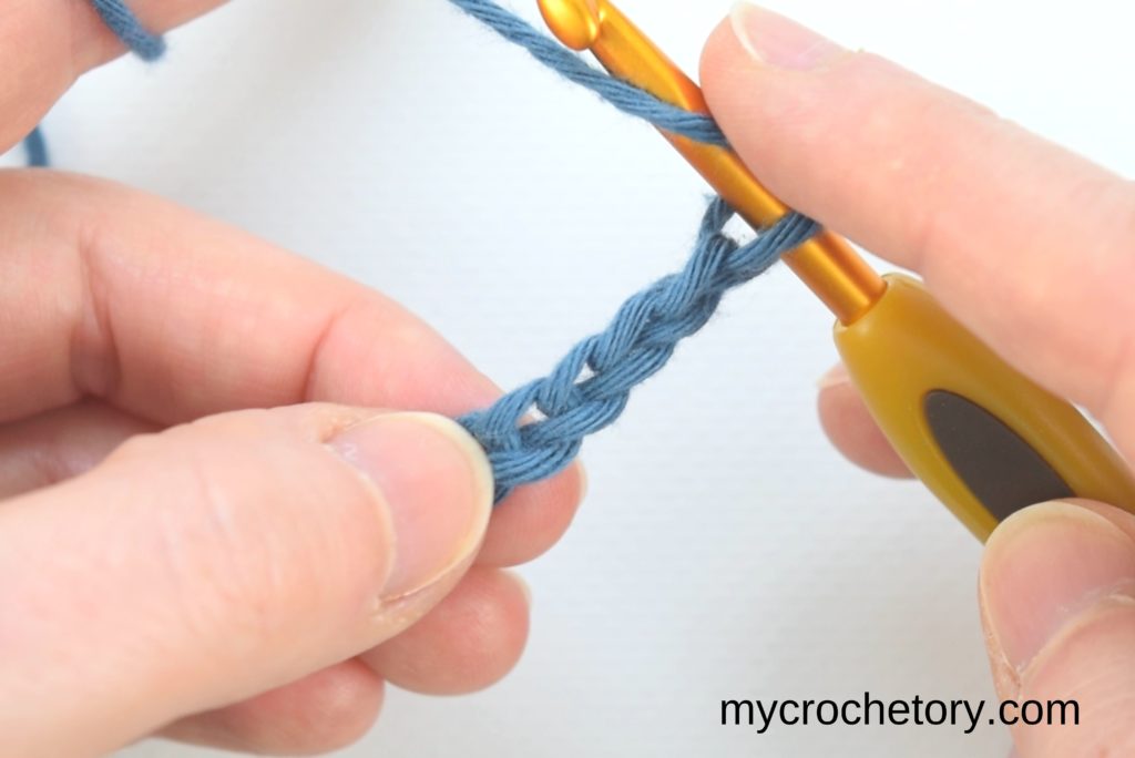 How to double crochet for beginners: yarn over and insert the hook in the 4th chain.