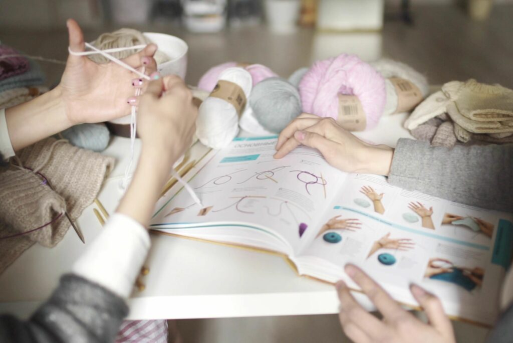 Relaxing crafting moment with knitting book for crochet vs knitting yarn enjoyment