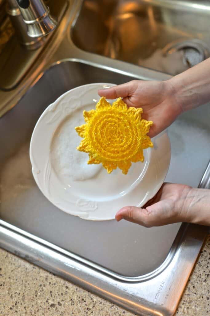 Sun's Out! Dish Scrubby - bright yellow sun-shaped scrubby, a fun addition to scrubby yarn crochet patterns.