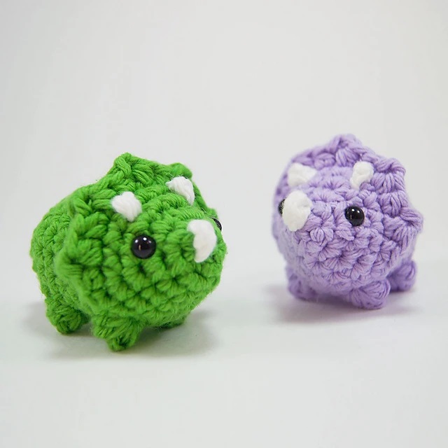 Easy crochet Triceratops with horns and a frill crown. This crochet animal pattern free is great for beginners