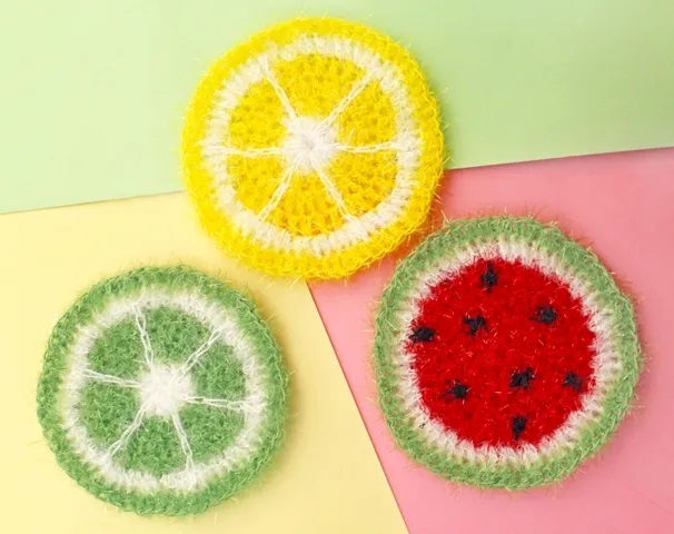 Crochet Fruit Scrubbies - fruit-shaped scrubbies in citrus, lime, and watermelon, great for scrubby yarn crochet patterns.