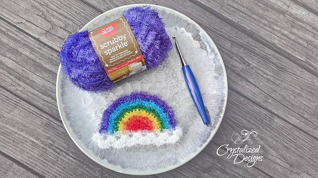 Rainbow Scrubby - colorful rainbow-shaped scrubby with sparkle yarn, included in scrubby yarn crochet patterns.