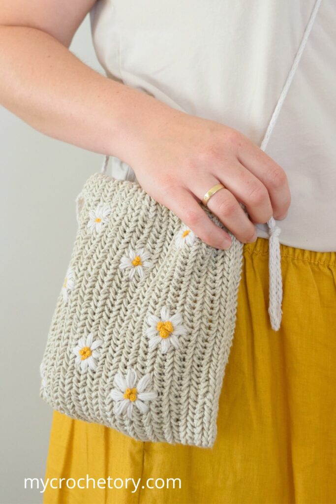 Close-up of crochet drawstring bag pattern with daisies
