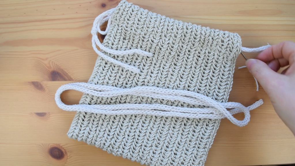 Top view of crochet drawstring bag pattern with I-cord drawstrings