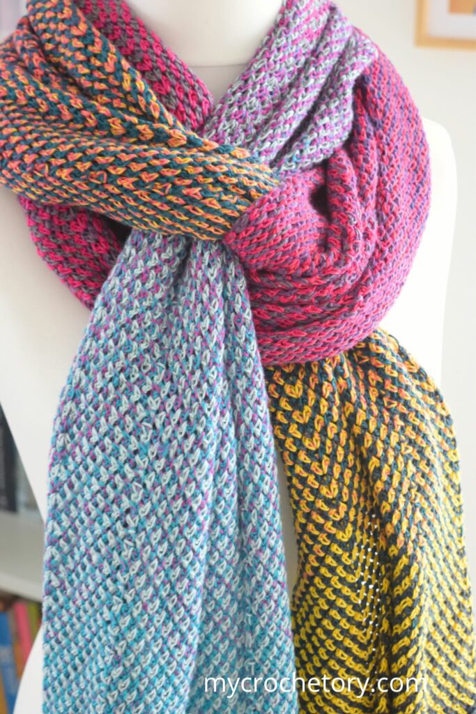 Close-up view of the vibrant Flourish Linen Wrap, a free pattern crochet scarf with intricate detailing,