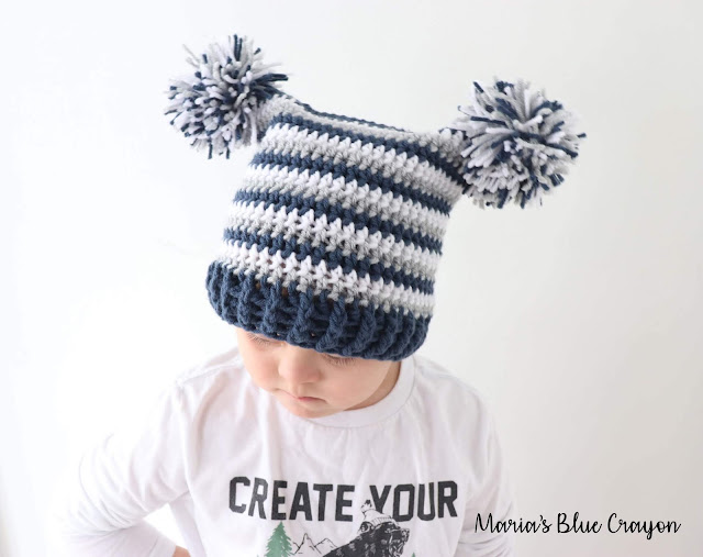 Fun striped infant crochet hat with two pom-poms, perfect for playful looks and keeping little ones warm, ideal for your infant crochet hat patterns.