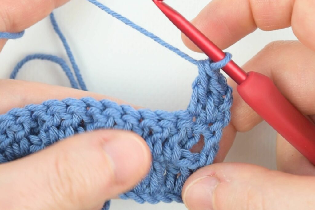 First two stitches of the third row in the waffle stitch crochet pattern.