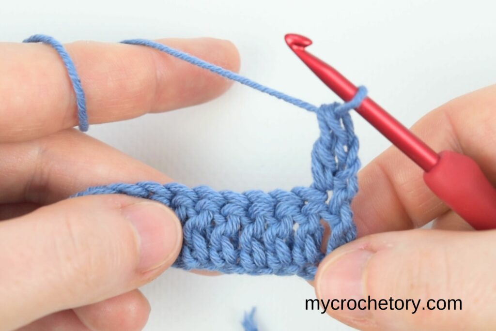 First double crochet in the waffle stitch crochet pattern.