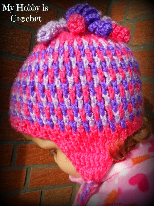 A vibrant crochet infant hat with colorful curls, showcasing adorable infant crochet hat patterns.